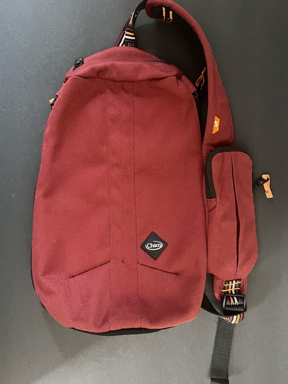 Chaco Men's Burgundy Red Sling Bag with Orange, Black and White Strap Detail